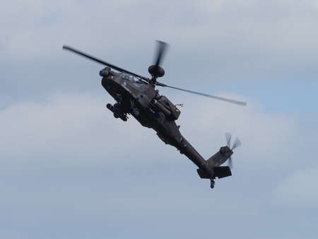 Duxford, UK - May 23rd 2015: An Apache Helicopter of the British Army, flying at Duxford VE Day Airshowのeditorial素材