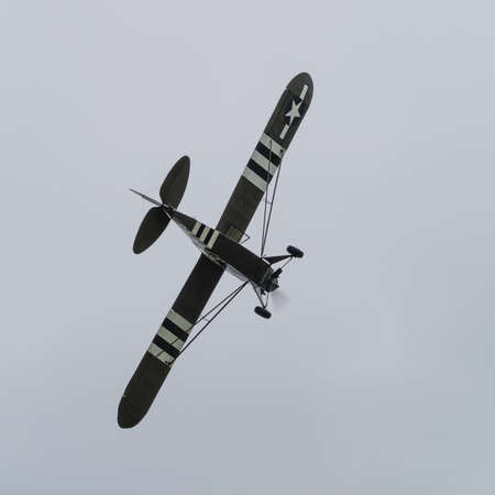 Duxford, UK - May 23rd 2015: A vintage US Piper L4 Cub aircraft, flying at Duxford VE Day Airshowのeditorial素材