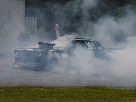 Goodwood, UK -26th June 2015: A heavily altered muscle car Ford Mustang 1965 'Hoonigan'. Performing 'donut' at the Goodwood Festival of Speed.のeditorial素材