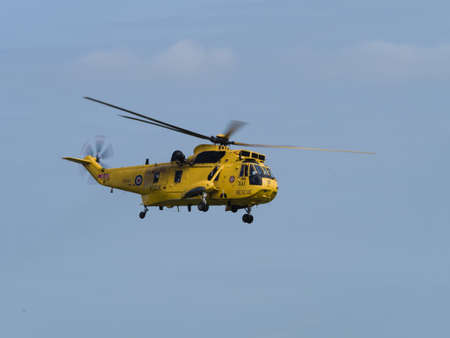 Duxford, UK - May 23rd 2015: An RAF Air Sea Rescue Sea King helicopter, flying at Duxford VE Day Airshowのeditorial素材