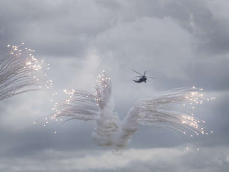 Helicopter releasing anti-missile flaresの写真素材