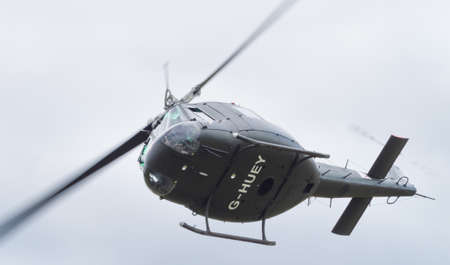 Yeovilton, UK - 11th July 2015: Vintage Bell 'Huey' helicopter flying at Yeovilton Air Day.のeditorial素材