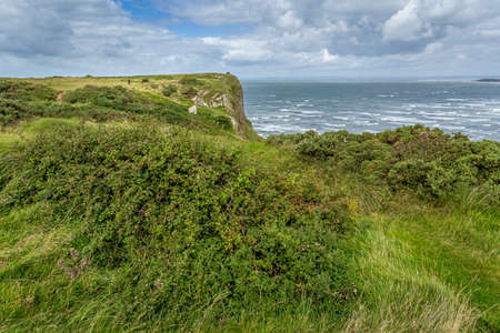 A landscape view of Rhossili Bay, on the Gower Peninsula, Swansea, South Wales, UKの写真素材