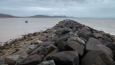 A landscape view of Lyme Regis cobb, a seaside town in Dorset, UK