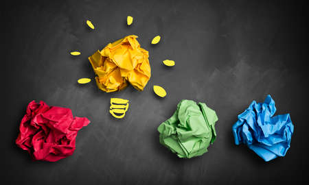crumpled paper in different colors and one as an ideaの写真素材