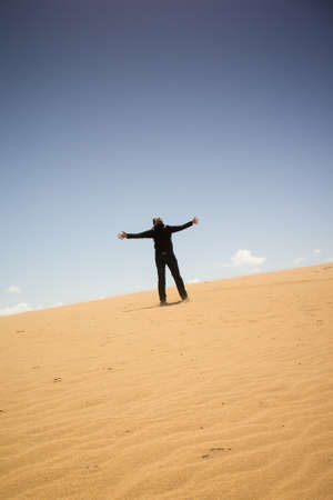 man standing alone on a duneの写真素材