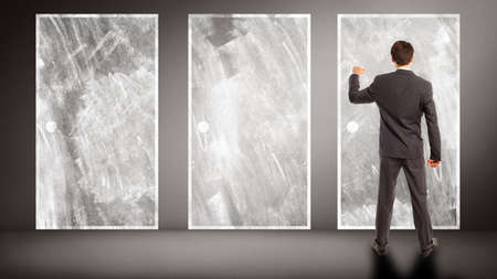 businessman knocking on a door, symbolizing that he made a decision out of three optionsの写真素材