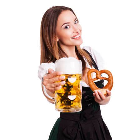 attractive woman in a traditional dirndl holding a beerの写真素材