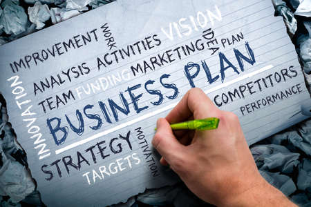 Man drawing a business plan tag cloud の写真素材