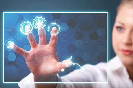 businesswoman pressing a virtual interfaceの写真素材