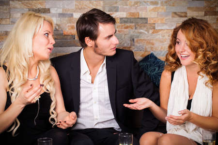 young woman telling her friends a story they don\'t believe の写真素材