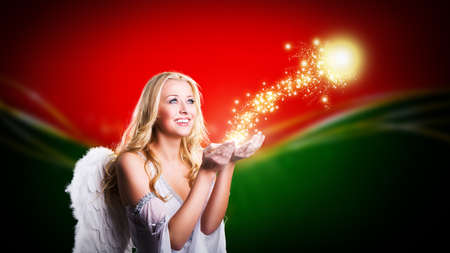 attractive blonde angel with christmas magicの写真素材