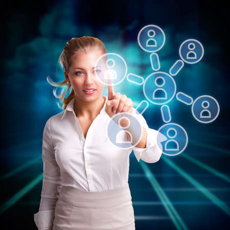 young woman touching a node in a networkの写真素材