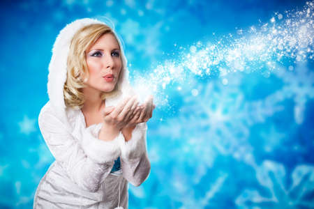 attractive blonde girl blowing twinkling stardustの写真素材