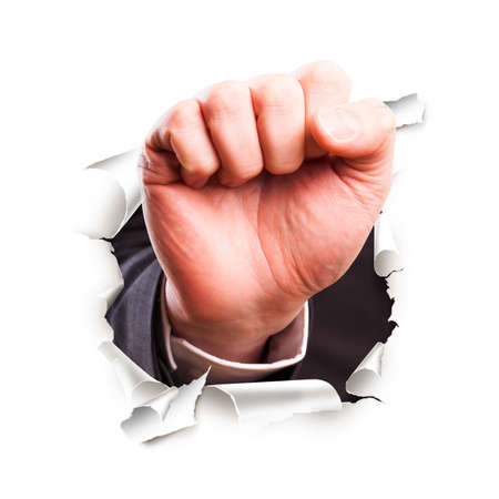 hand with knocking gesture breaking through wallの写真素材