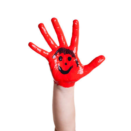 painted hand of a child with a smileyの写真素材
