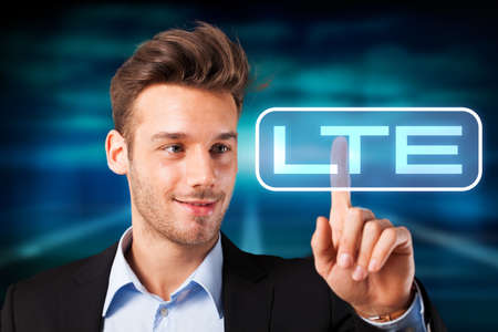 business man pressing button on LTEの写真素材