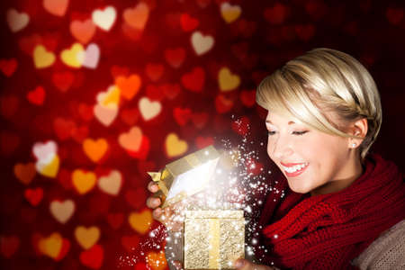 attractive blonde girl with a presentの写真素材