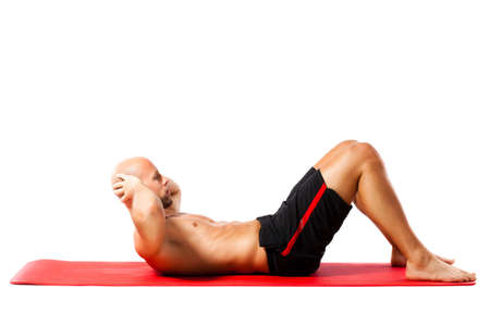 muscular man doing sit-upsの写真素材