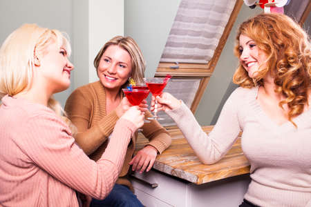 three women clinking glassesの写真素材