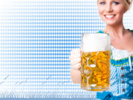 beautiful woman in a traditional bavarian dirndl with a beerの写真素材