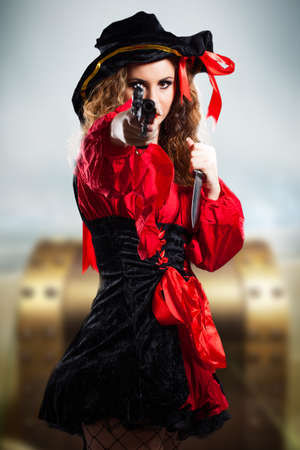 attractive brunette pirate girl with a gunの写真素材