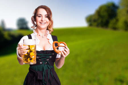 beautiful woman in a traditional bavarian dirndl with a beerの写真素材