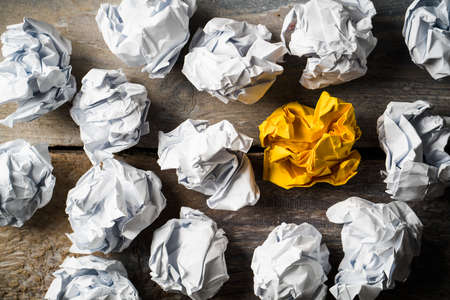 crumpled paper symbolizing different solutions with one standing out with a different color