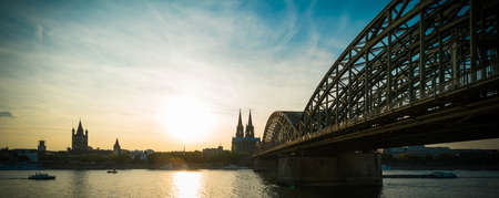 Cologne with the Hohenzollern Bridge and the Cathedral at sunsetの写真素材