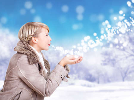 attractive blond woman in a winter sceneの写真素材
