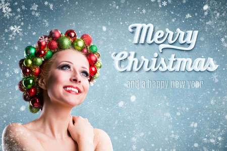 attractive blonde girl with snowflakes and "Merry Christmas" messageの写真素材