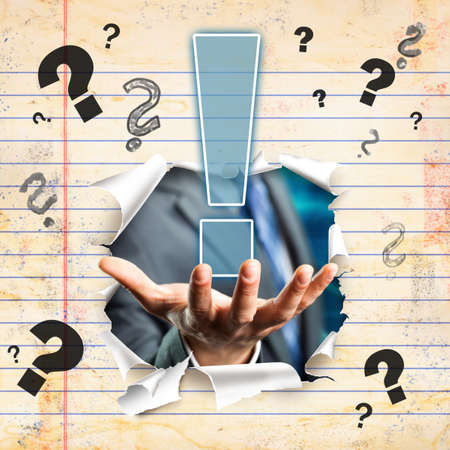 businessman breaking through a wall presenting a solutionの写真素材