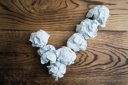 crumpled paper symbolizing different solutions forming a checkmarkの写真素材
