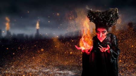 scary witch summoning a spell in a dark environment