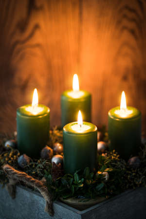 modern Advent arrangement with lit candles on wooden tableの写真素材
