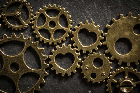 cogwheels with hearts symbolizing a romantic relationship binding two families togetherの写真素材