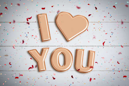 Balloons forming the words I love you on wooden background
