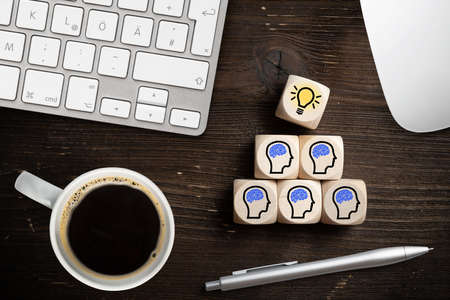many people together having an idea symbolized by icons on cubes