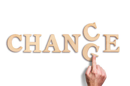 hand moving a letter, turning the word change to chance