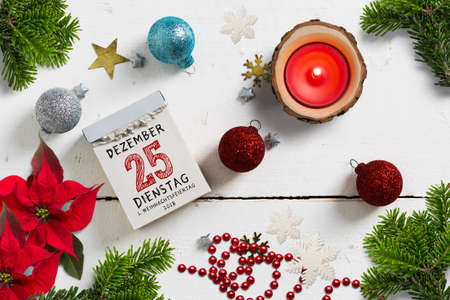 tear-off calendar with 25th of december 2018 (in German) on top on a wooden surface