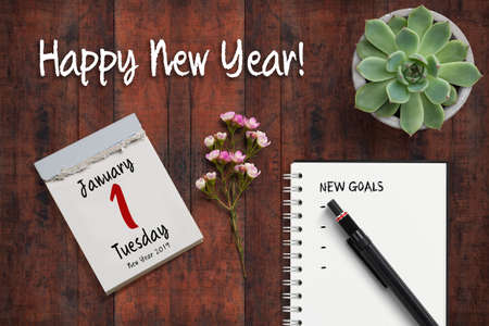 tear-off calendar with 1st of january 2019 and notebook with checklist of new goals