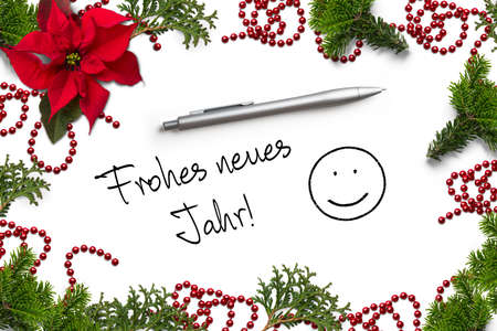 Christmas decoration and the German message for "Happy new year!" on white backgroundの写真素材