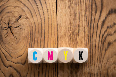 cubes with colored letters for CMYK on wooden backgroundの写真素材