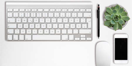 modern computer workplace with keyboard and other office utensils isolated on white