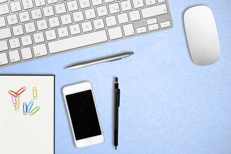 modern computer workplace with keyboard and other office utensils