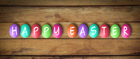 Easter Eggs on wooden background with message Happy Easter