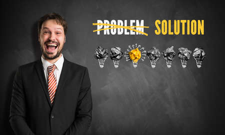 businessman in front of an blackboard having an ideaの写真素材