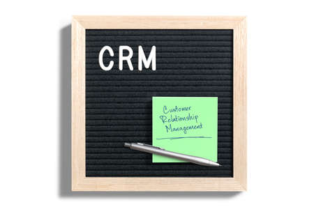 Acronym CRM on a letterboard with a note explaining it asの写真素材