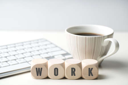 cubes with letters forming the word WORK in front of a keyboard cubes with letters forming the word WORK in front of a keyboard