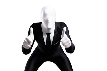 Creepy faceless guy in tight business suit showing approval with thumbs up over plain white backgroundの写真素材